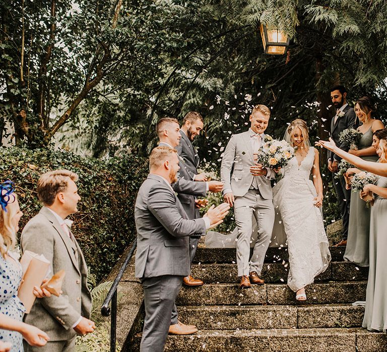 Bride and groom confetti exit at church wedding