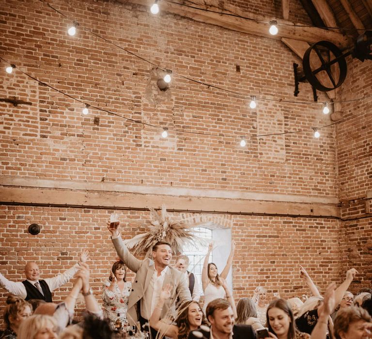 Wedding party cheers during ceremony 