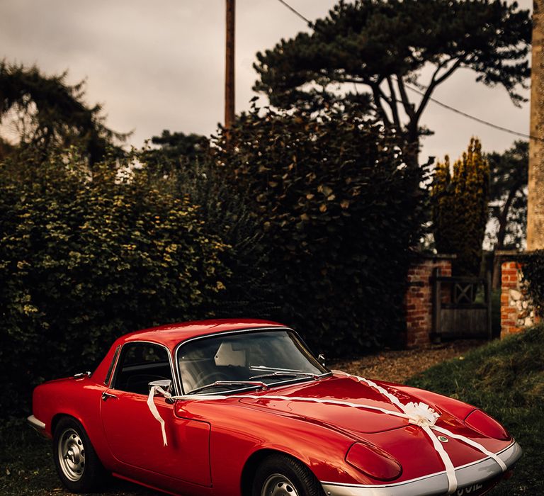 Red vintage wedding car at Oxnead Hall wedding venue