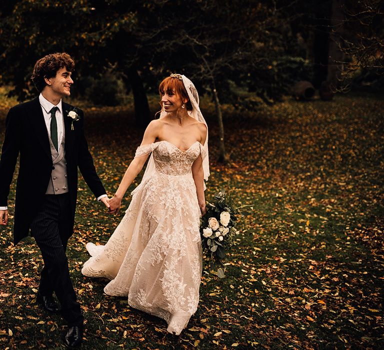 Bride and groom walk hand in hand