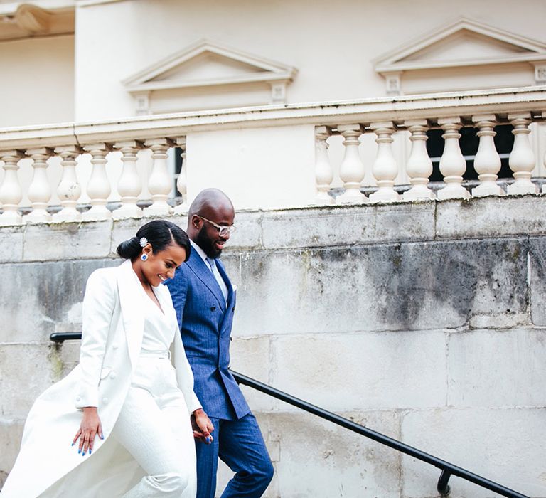 Bride & groom walk up steps to registry office on their wedding day