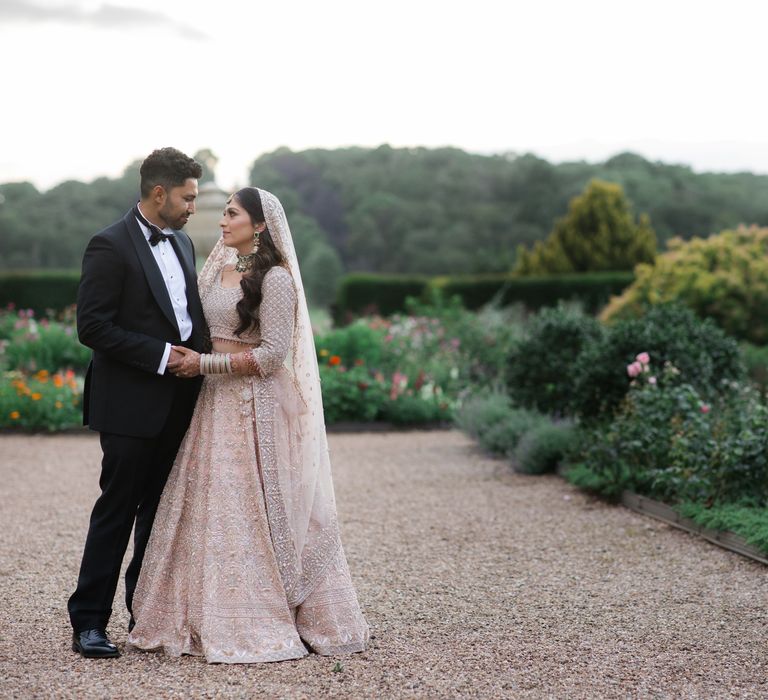 Bride & groom kiss outdoors on their wedding day at Ragley Hall