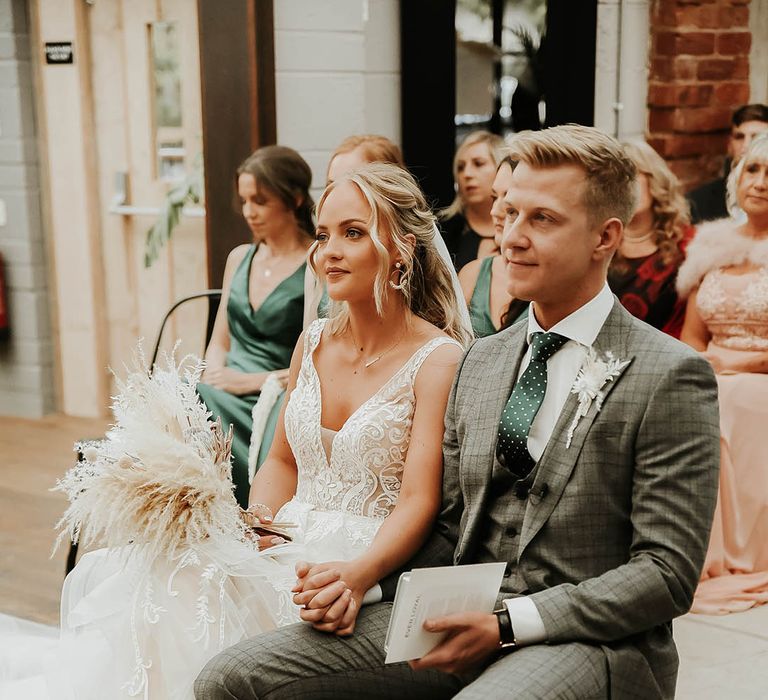 Bride and groom hold hands during civil ceremony at The Shack Revolution