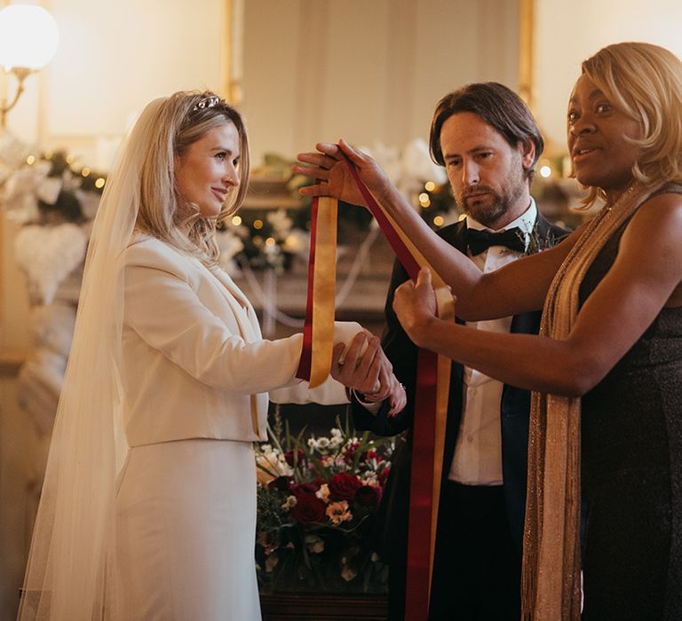 Bride & groom during handfasting ceremony at Gosfield Hall 