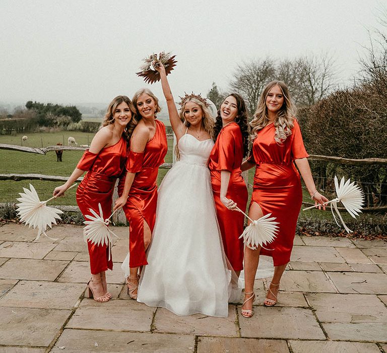 Bridal party in orange bridesmaid dresses