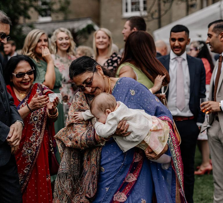 Multicultural back garden wedding with wedding guest enjoying the celebrations 