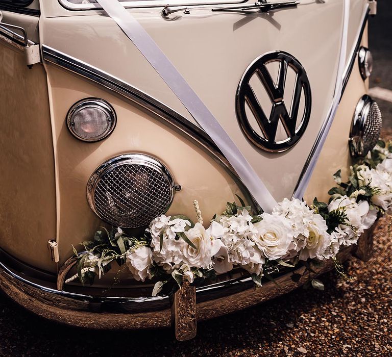 Cream VW wedding car decorated with white flowers 