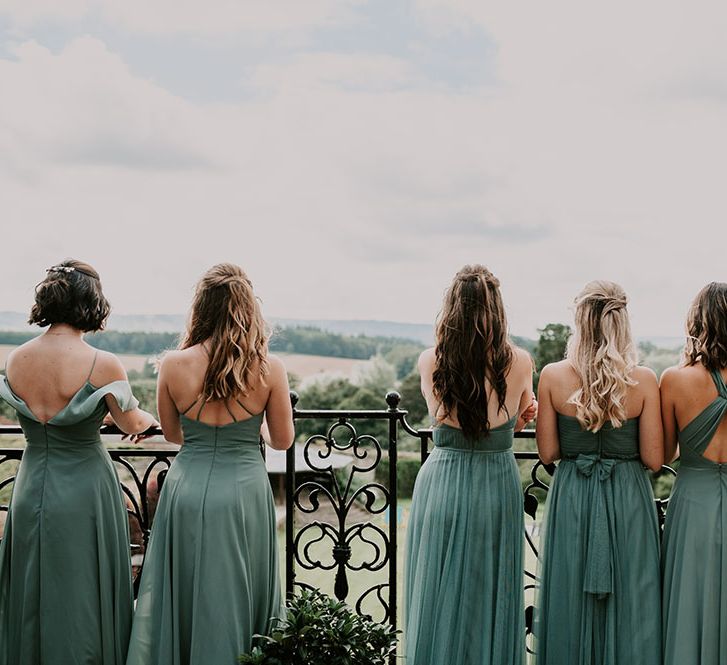 Bridesmaids wear green bridesmaid dresses in different styles for Cowdray House wedding 