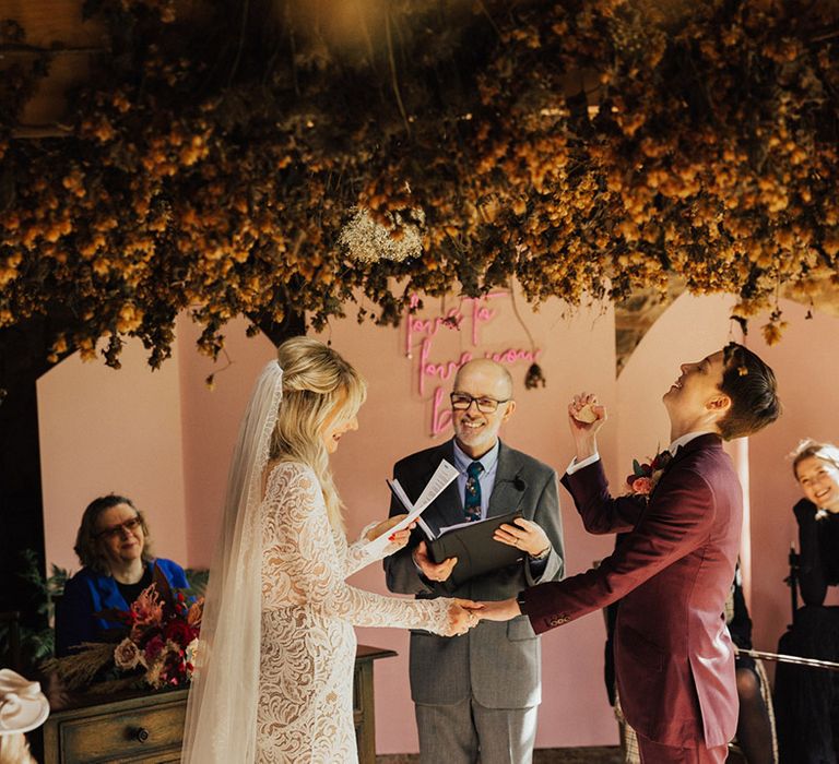 Couple stand as the bride reads her wedding vows during the wedding ceremony 