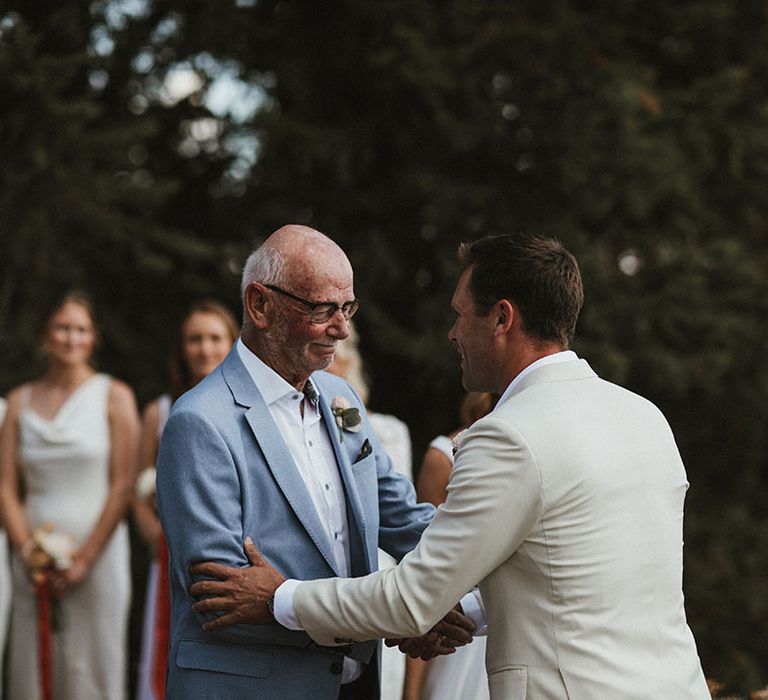 Groom shakes Father of The Brides hand during wedding ceremony 