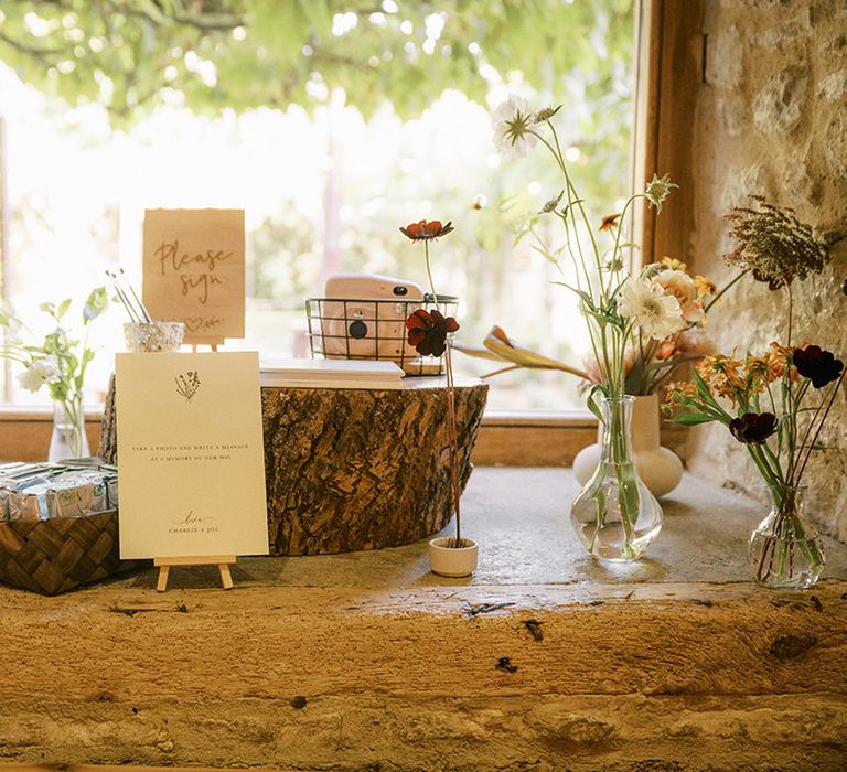 Polaroid wedding guest book idea on tree trunk stands for rustic barn wedding 