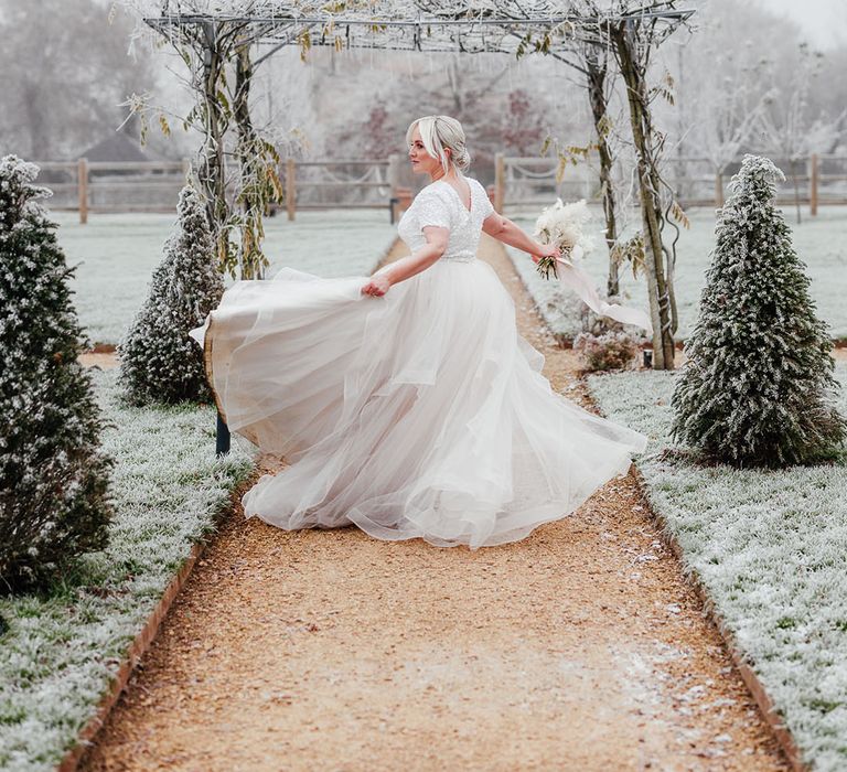 Bride in princess style bridal separates spinning her skirt around at the grounds of Silchester Farm wedding venue