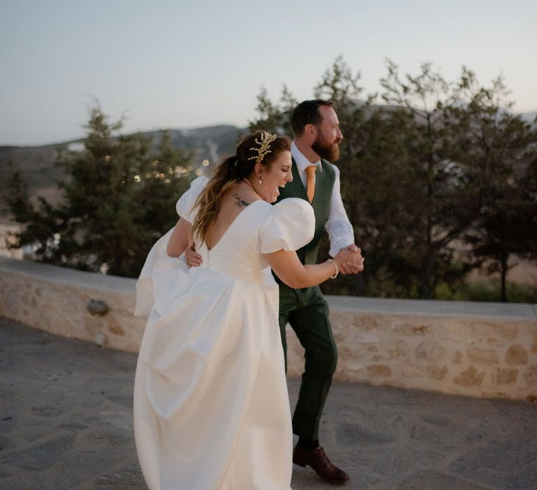 Bride and groom share fisrt dance during dusk at private villa wedding in Greece