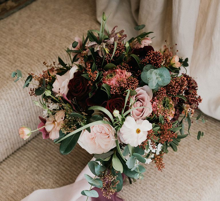 Red and pink wedding bouquet with roses to match the red and pink bridesmaid dresses 