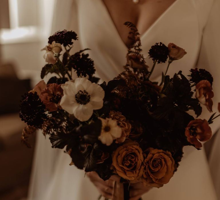 Dusky pink, white and burnt red dried flower, rose and peony bridal bouquet with yellow and black ribbon