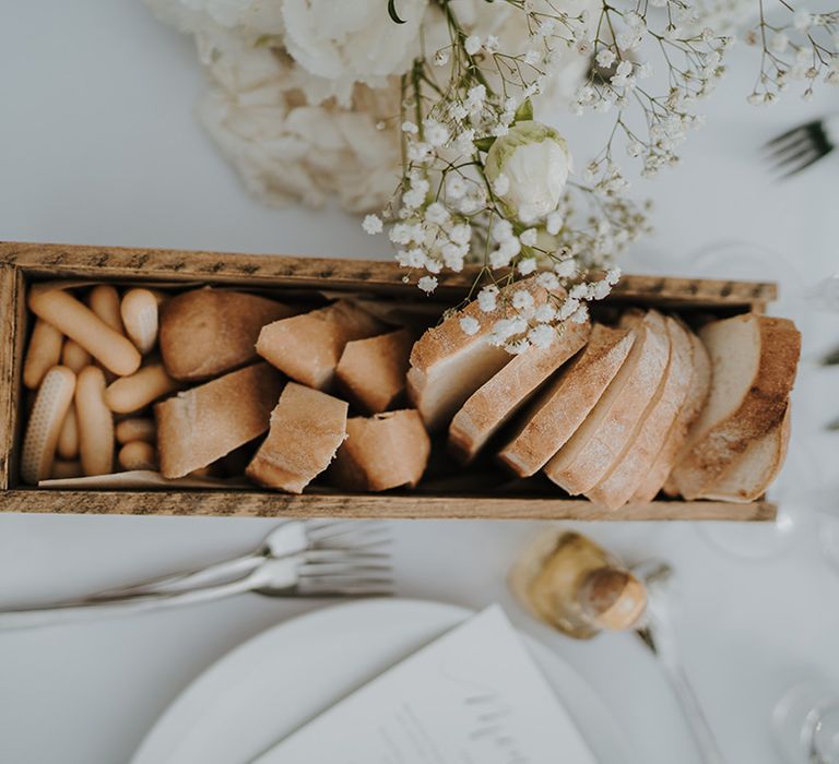 wooden box with bread roll and breadsticks at pure house ibiza wedding