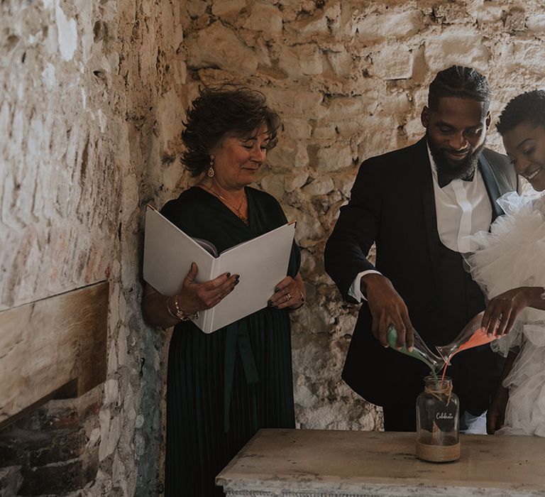 Sand pouring wedding ceremony for bride and groom at historic wedding venue 