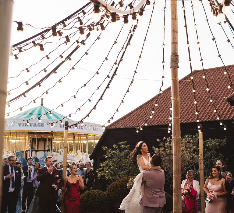 Festoon lighting decorating the Preston Court wedding venue for the bride and groom to have an outdoor first dance 