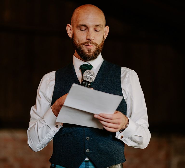 Groomsman reads out wedding speech at the wedding 