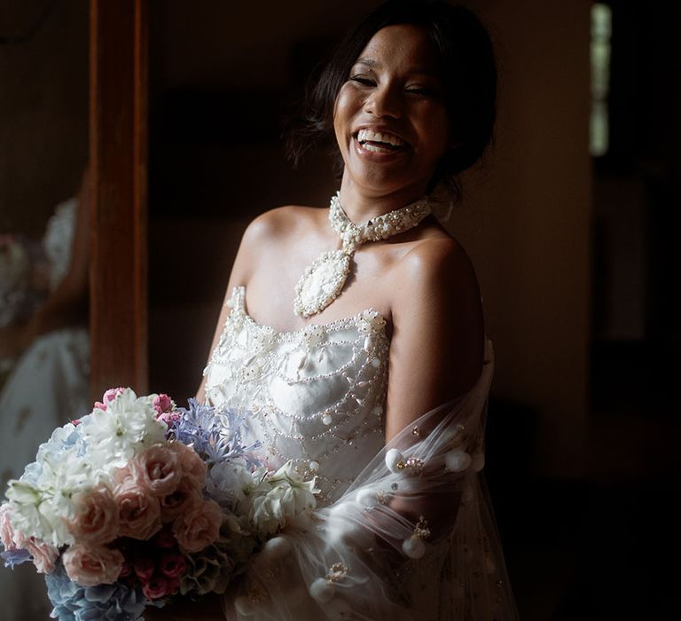 Bride in a strapless princess wedding dress with pearl detailing 