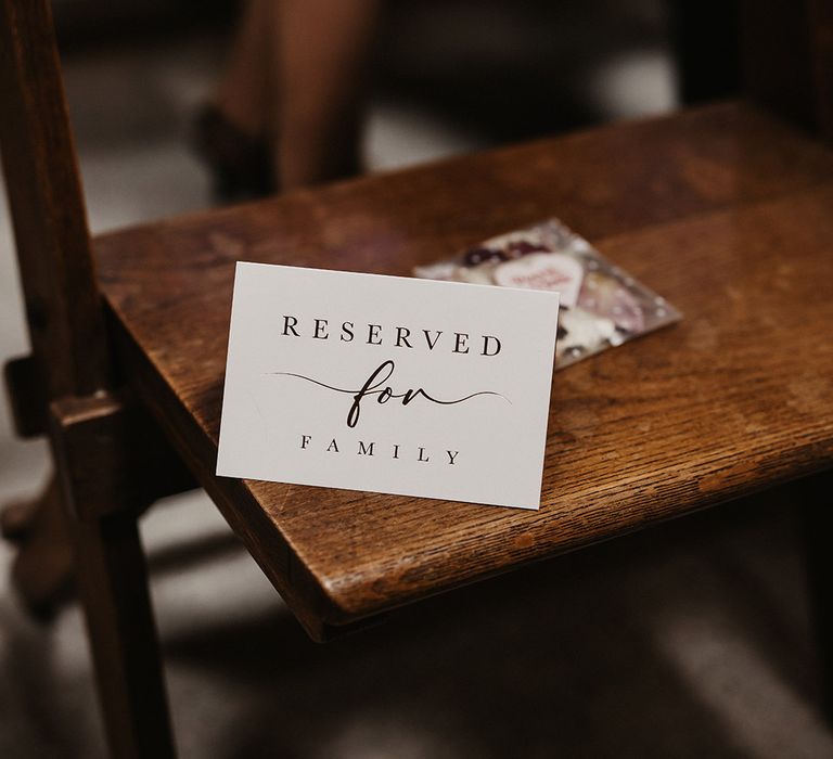 Reserved wedding seat sign at wedding ceremony on wooden chair 