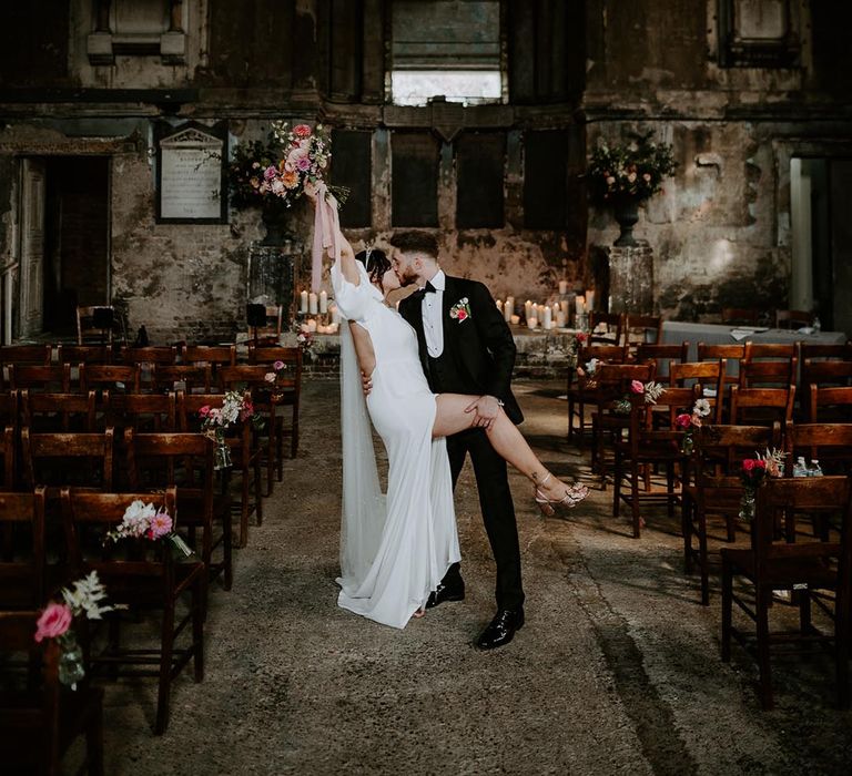 Unique wedding venue in London with the bride and groom posing together 