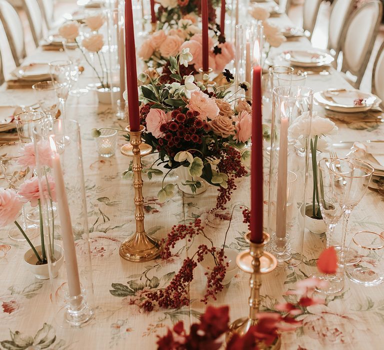 Red and pink autumnal style wedding tablescape with wedding flower centrepieces 