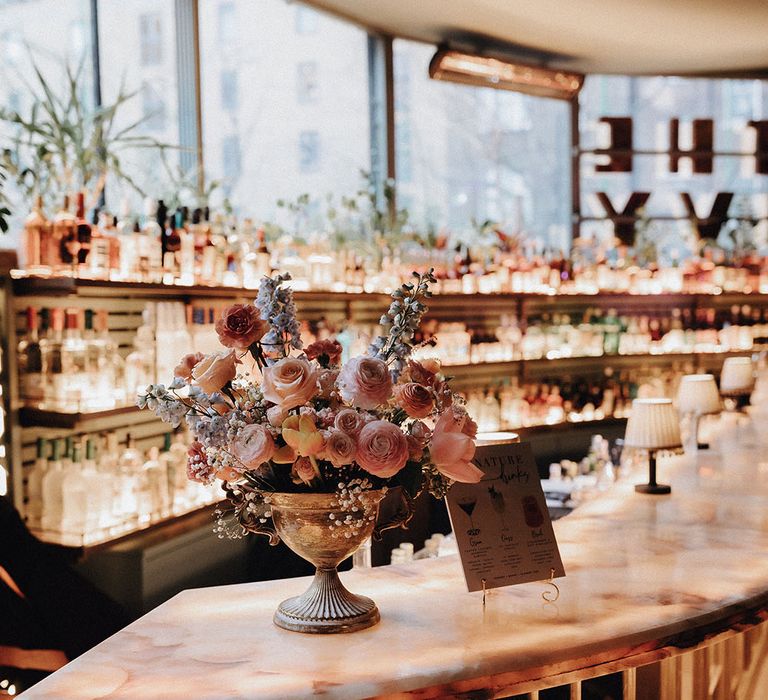 Sophisticated wedding bar design with pastel flowers at The Ivy