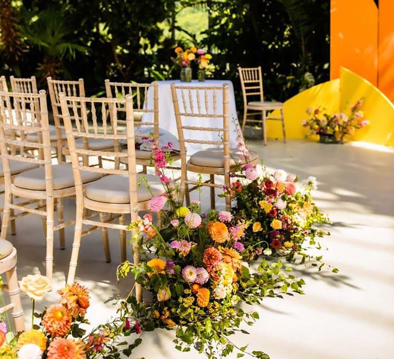 Colourful meadow aisle flower arrangements 