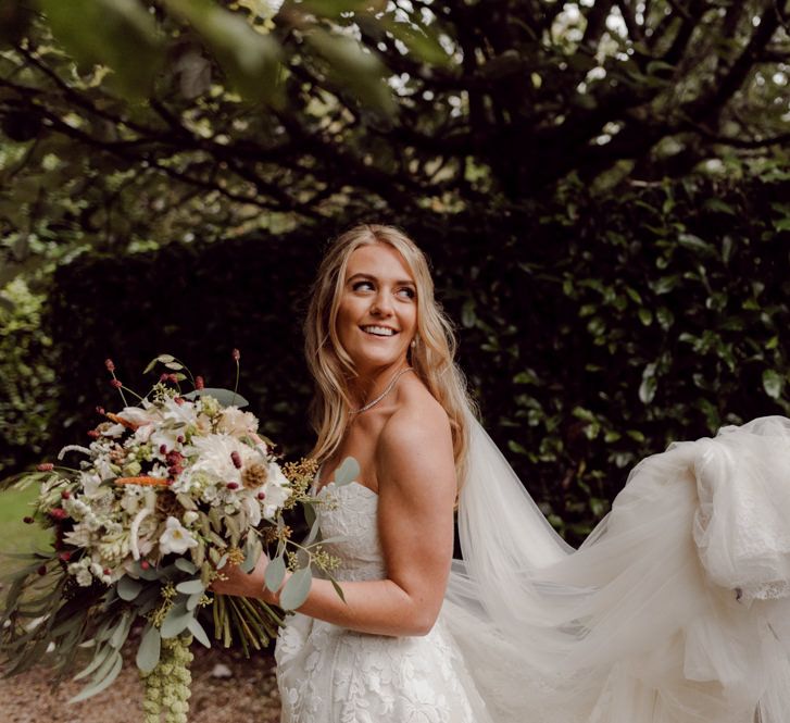 Bride carries gorgeous blush bouquet