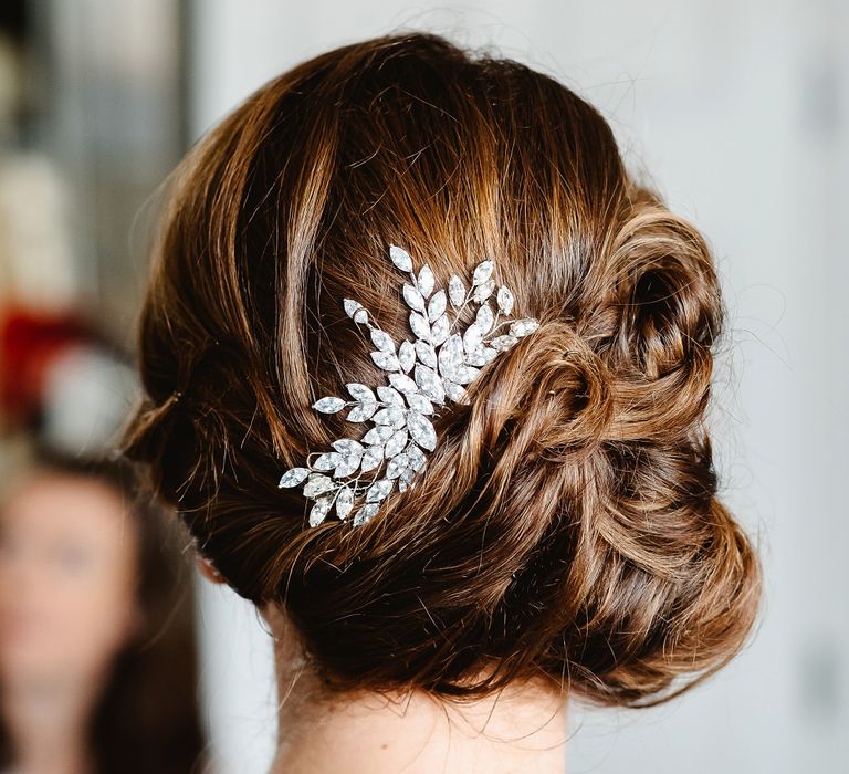 pinned bridal updo with jewel accessory 