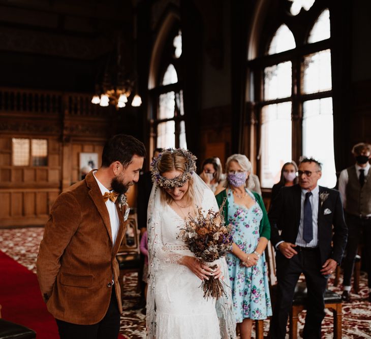 Socially distanced wedding ceremony bridal entrance in flower crown and embroidered veil