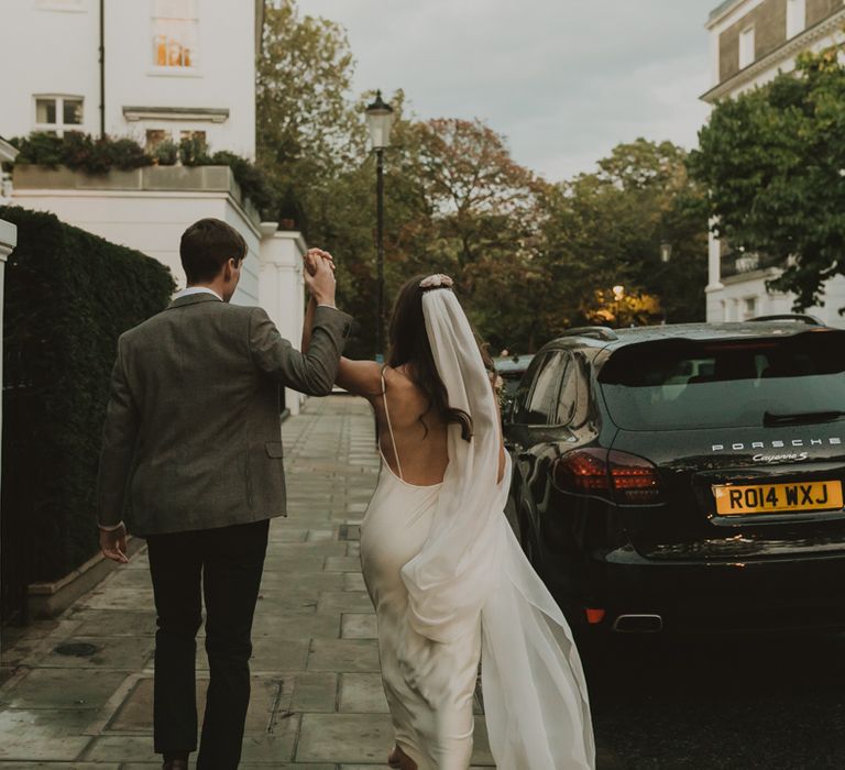 Bride and groom walking down the street in London 