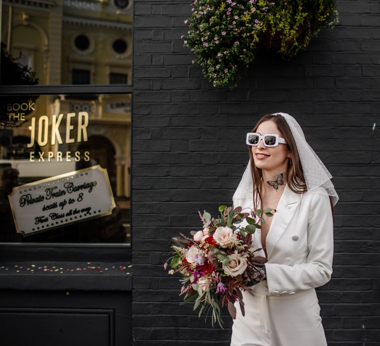 Alternative bride in jumpsuit and sunglasses at Brighton micro wedding 