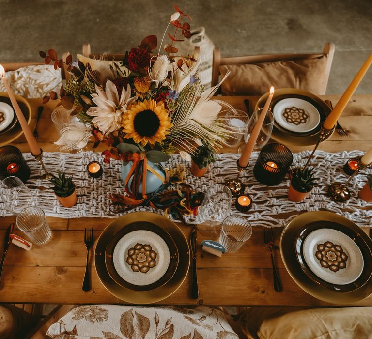 Macrame table runner, succulents and candles decorating the wedding table 