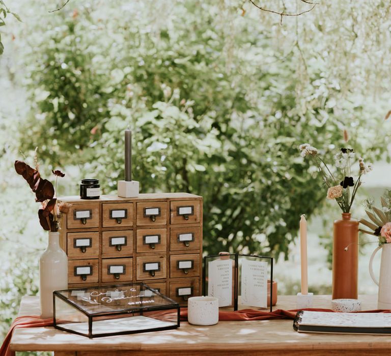 Cards and guest book table with candles and wooden box decor 