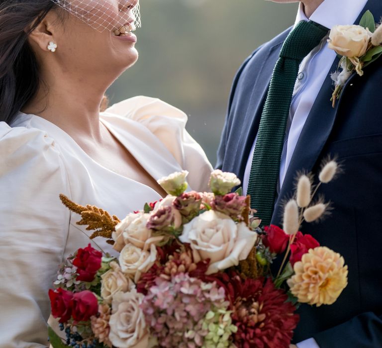 Red, cream and yellow wedding bouquet with hydrangeas, dahlias and roses 