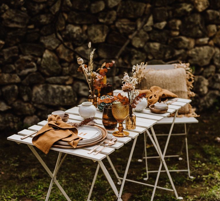 Outdoor table setting with white wooden table