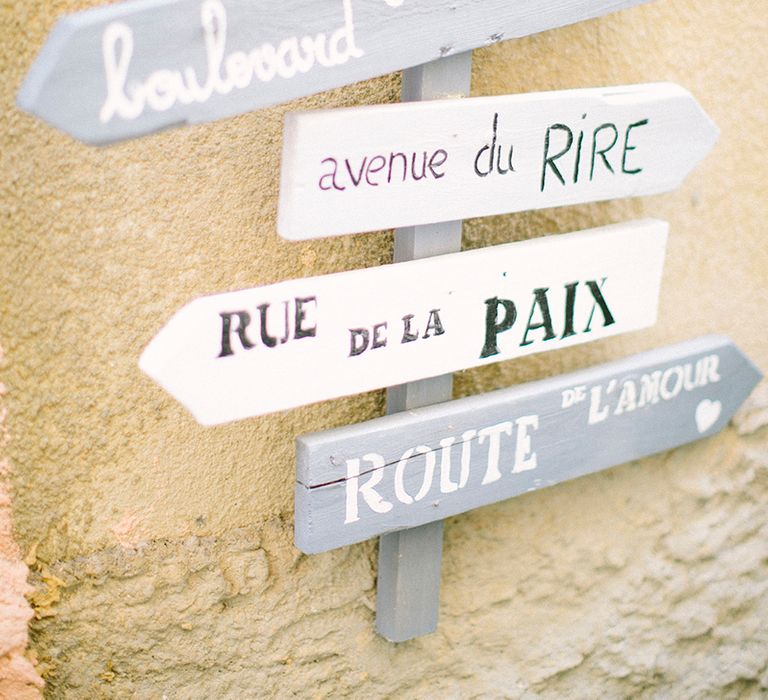 French signage in blue, white and grey wood. Photography by Saya Photography.