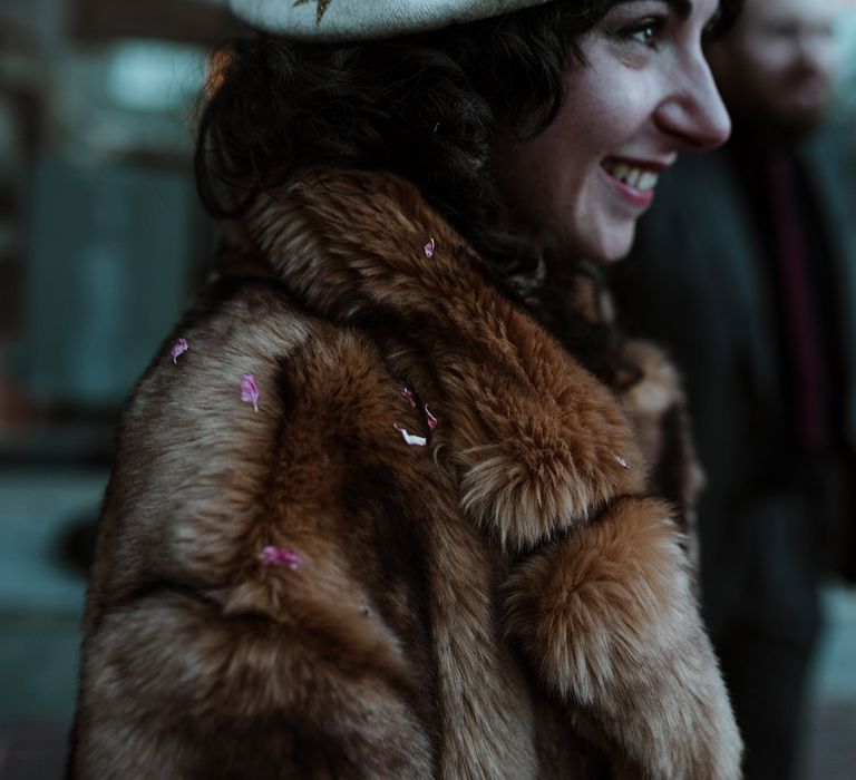 Confetti on brides shoulder at winter wedding