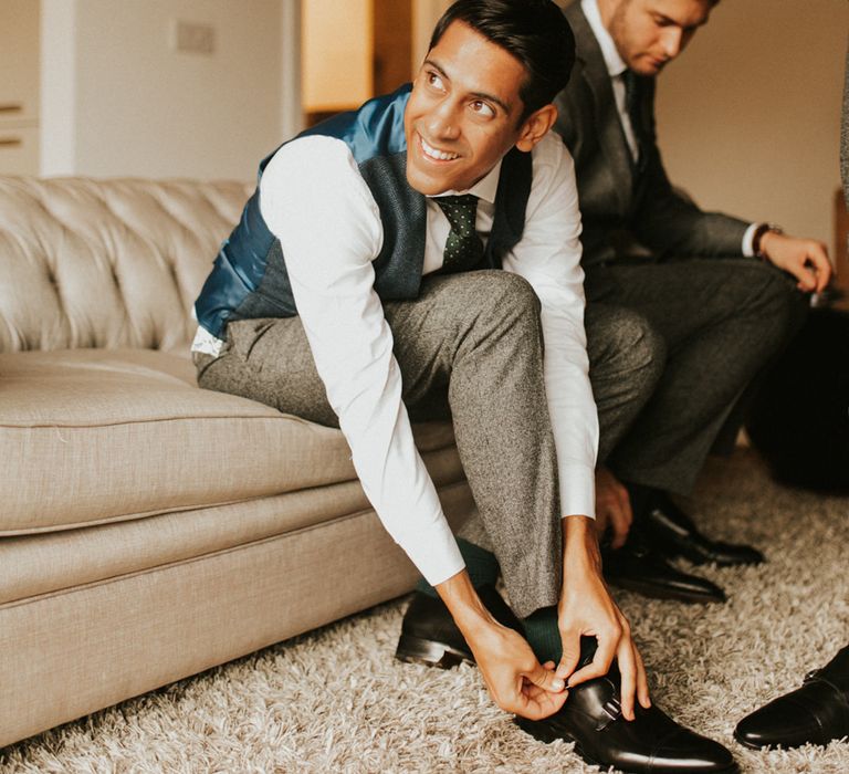 Groom on the wedding morning putting on his double monk shoes 