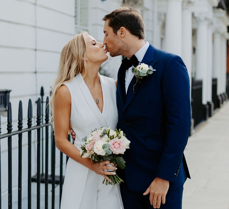 Bride & groom kiss after wedding ceremony in London