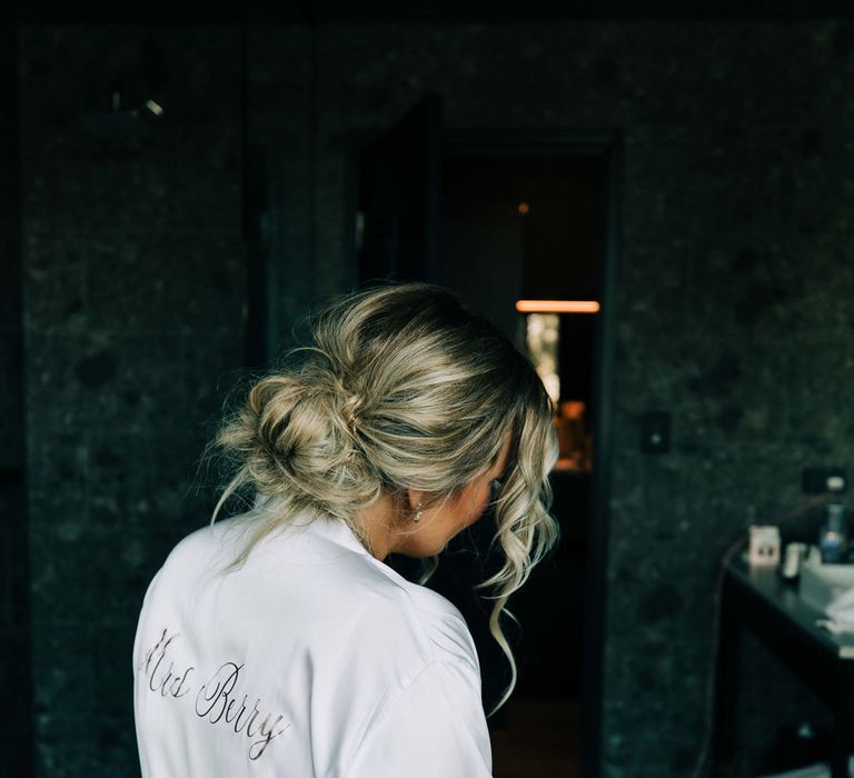 Bride with pinned undo wearing personalised getting ready robe