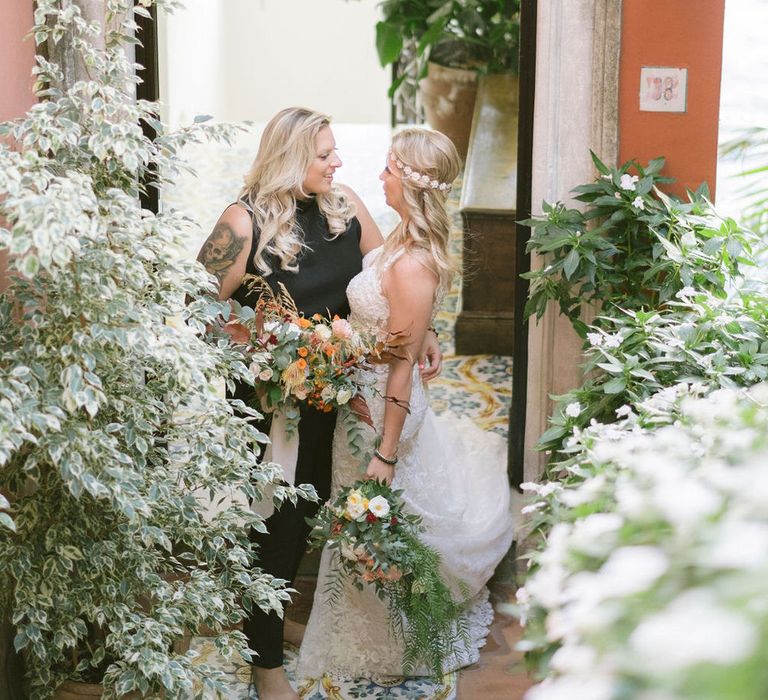 The two barefoot brides share a moment after their ceremony at Hotel Marincanto