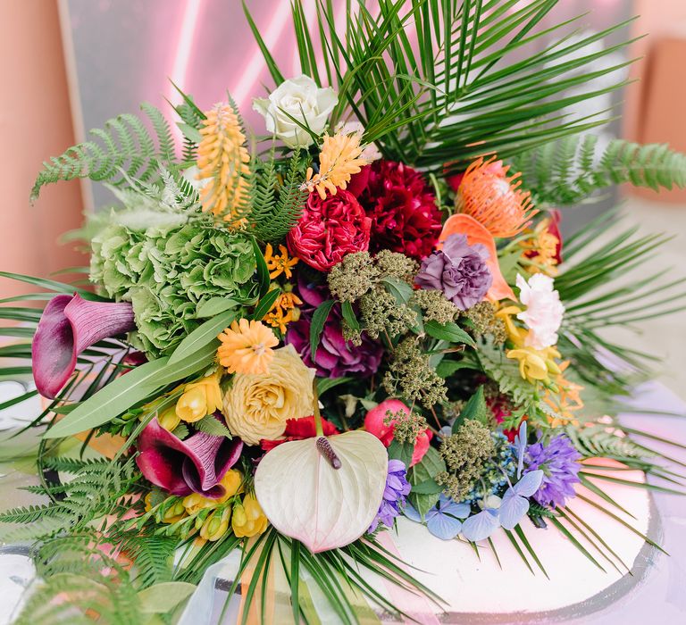 Bouquet featuring bright and bold summery blooms and green foliages