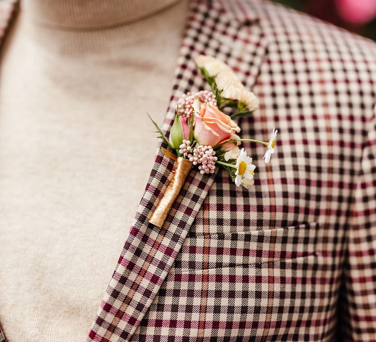 Groom in a beige polo neck and check blazer with wildflower buttonhole 