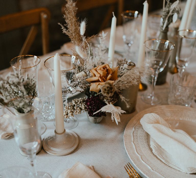 Dried and fresh flower stems in bottles at modern luxury wedding reception 