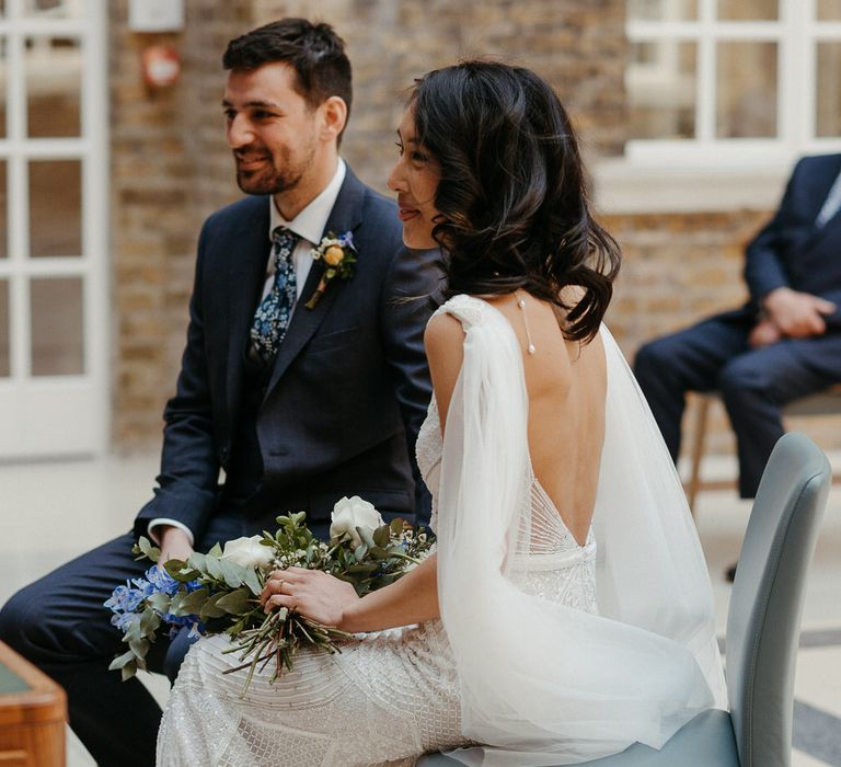 Bride and groom sat at the altar getting married at Hackney Town Hall