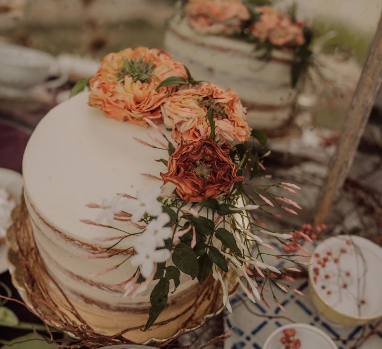 Naked wedding with white frosting and bright floral decor 