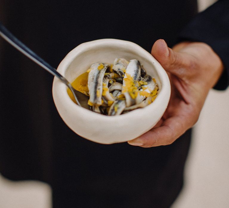 Anchovies in white bowl for wedding reception dinner